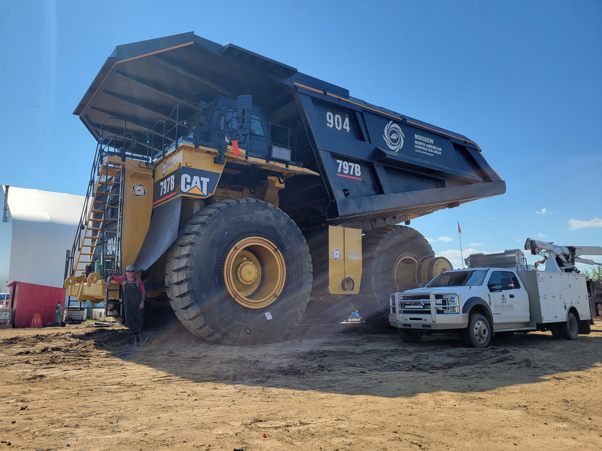 BSD service truck on-site at a mine, alongside a CAT 797B haul truck