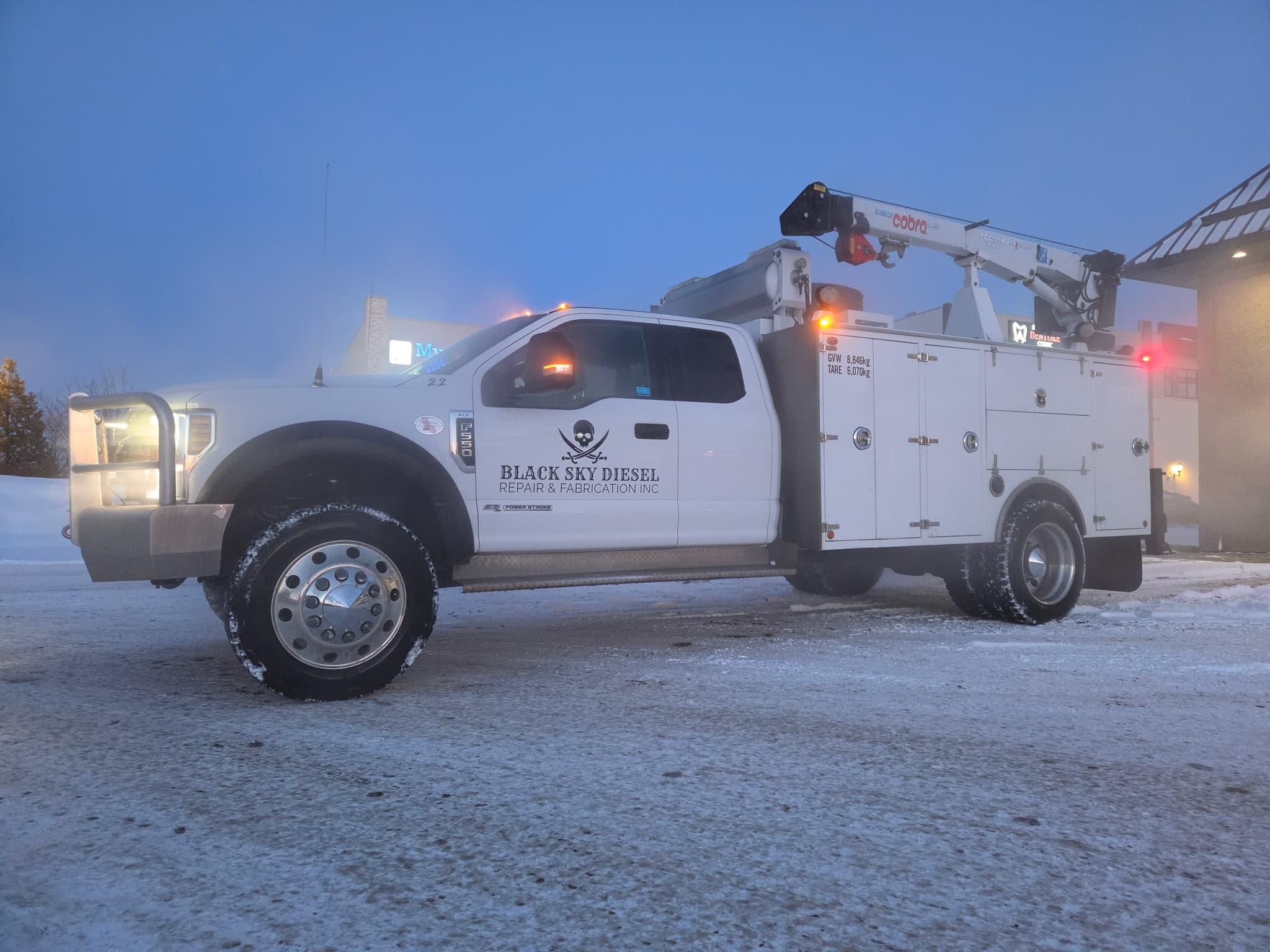 BSD service truck in winter weather, picker crane visible