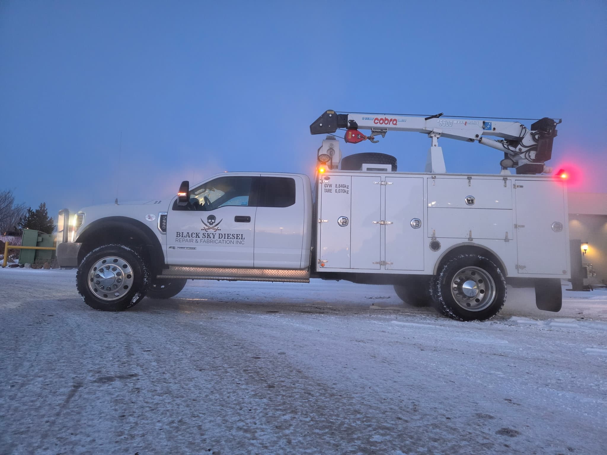 BSD service truck side view showing the Cobra picker crane and service body